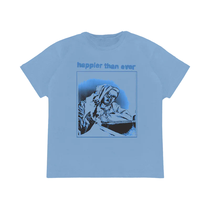 Light blue T-shirt featuring a monochrome graphic of Billie Eilish talking on the phone with "happier than ever" text, part of the Billie Eilish merch collection.