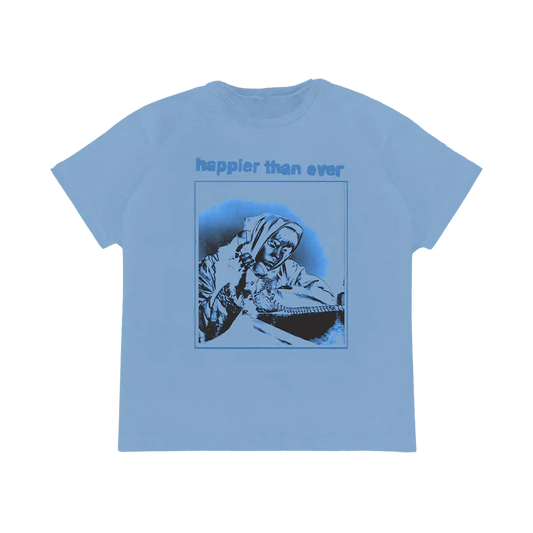 Light blue T-shirt featuring a monochrome graphic of Billie Eilish talking on the phone with "happier than ever" text, part of the Billie Eilish merch collection.